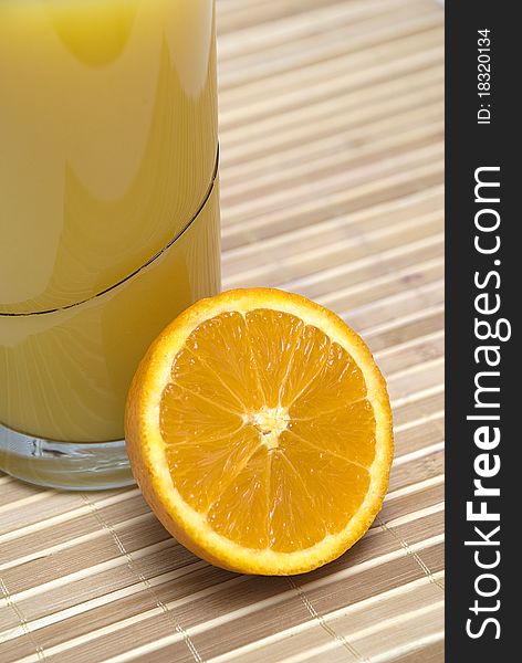 Glass with orange juice and a sliced orange