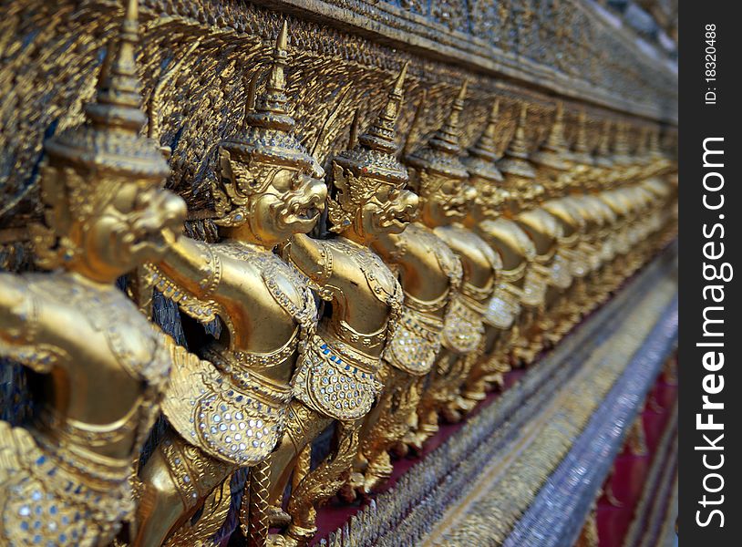 The overgilded dragons on a facade of a royal palace in Bangkok