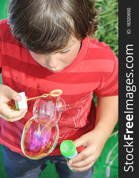 Little boy blowing soap bubbles. Little boy blowing soap bubbles