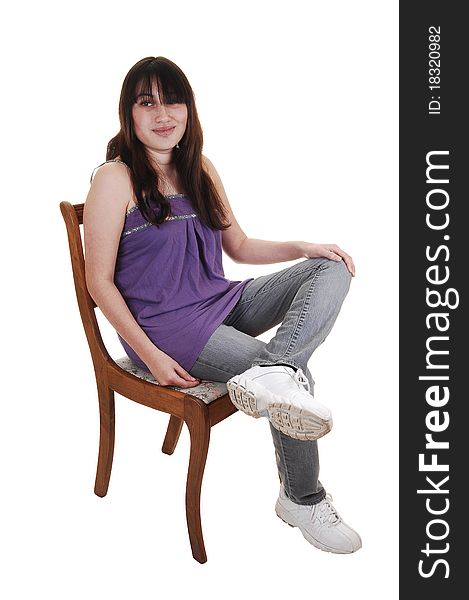 A young girl sitting on an old chair, for white background.