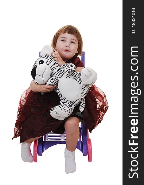 A sweet little girl, three years old, in a nice burgundy dress having fun with her stuffed animal, for white background. A sweet little girl, three years old, in a nice burgundy dress having fun with her stuffed animal, for white background.