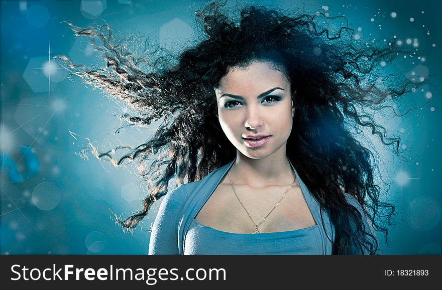 Woman with a long beautiful hair on blue background