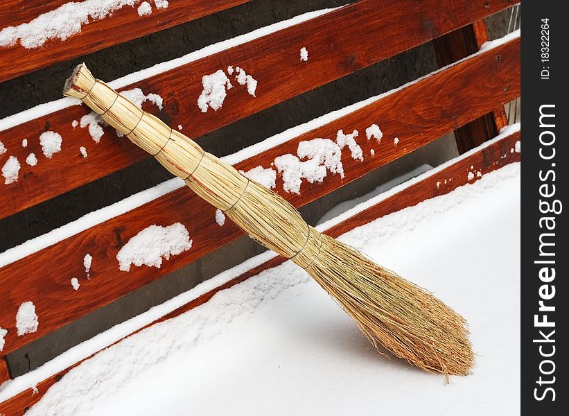 Broom in the snow on a park bench. Broom in the snow on a park bench.