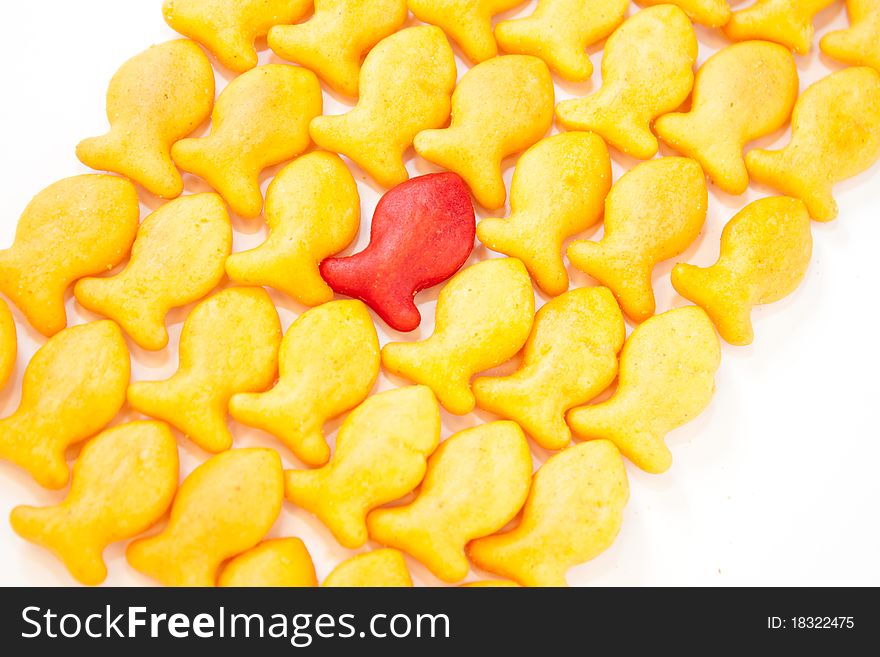 Gold Fish Crackers. One red. Background.