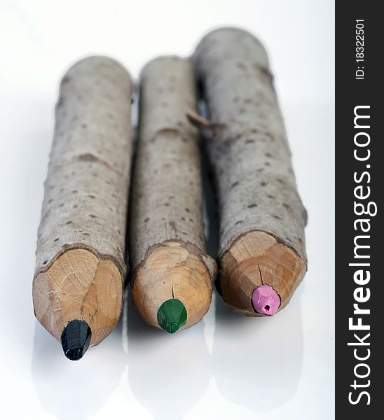 Crayons made of a whole branch on a white background