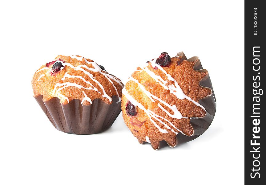 Muffins with red bilberry on a white background