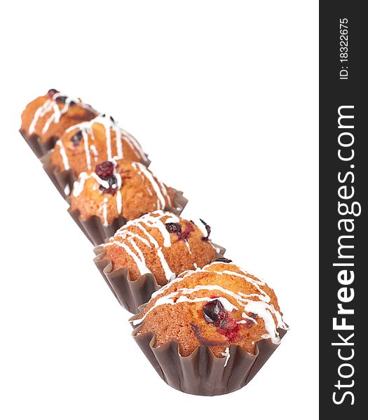 Muffins with red bilberry on a white background