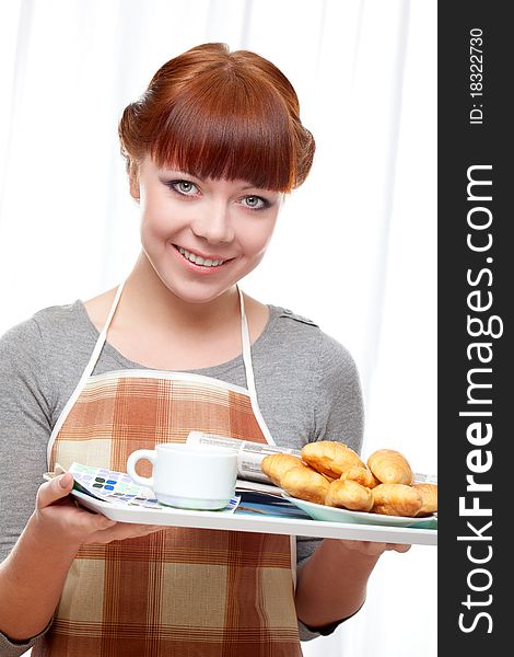 Housewife holding tray with breakfast