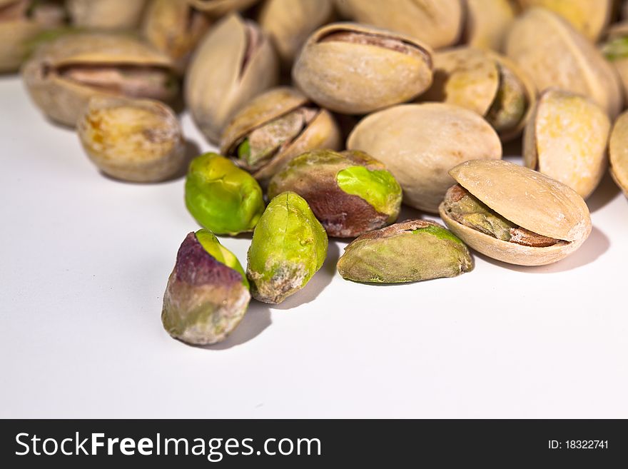 Close-up photo of pistachio nut on white background