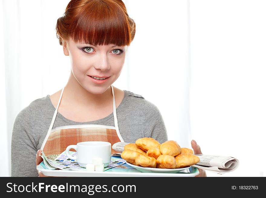 Housewife holding tray with breakfast over white