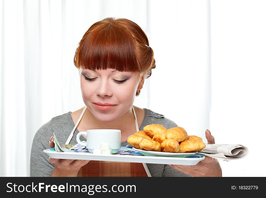 Housewife holding tray with breakfast over white