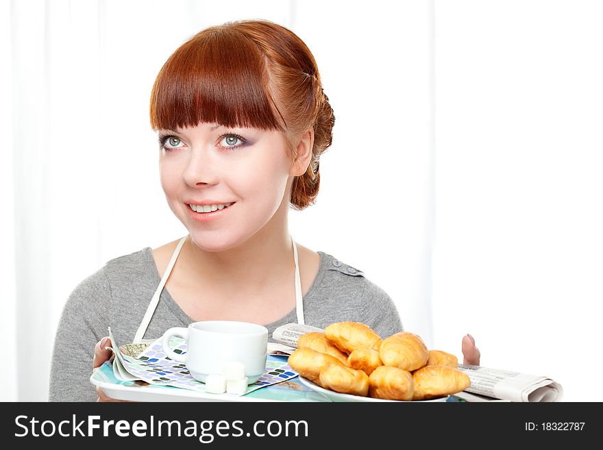 Housewife holding tray with breakfast over white