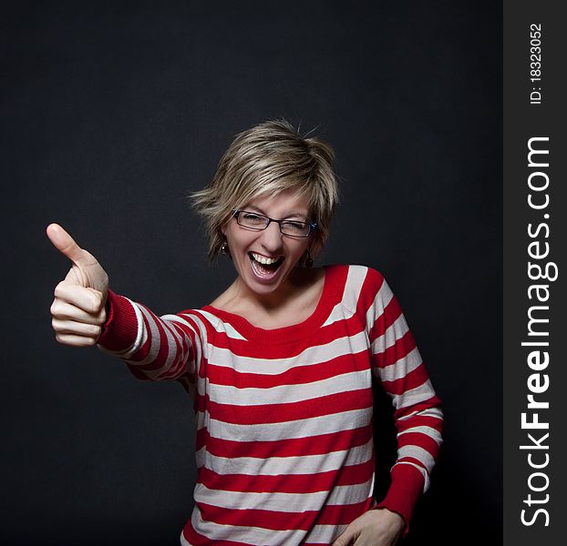 Portrait of attractive woman on black background showing thumb up. Portrait of attractive woman on black background showing thumb up