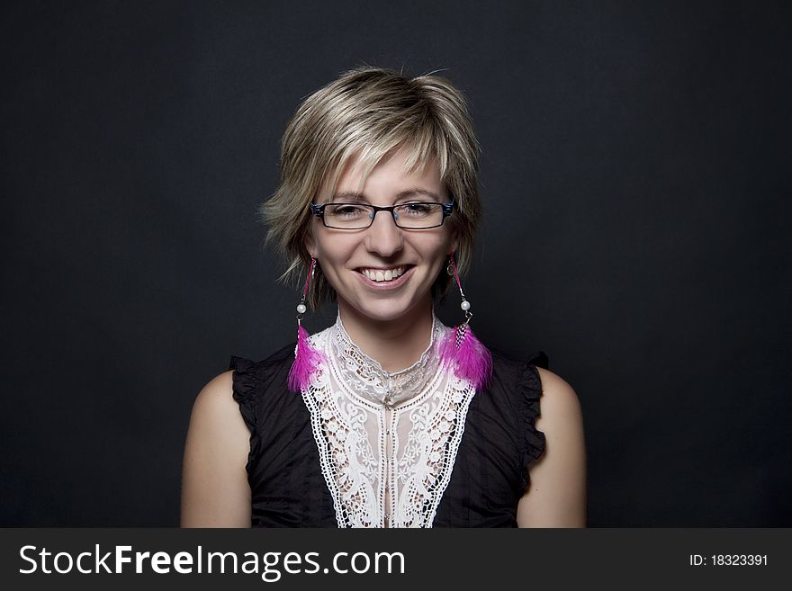 Woman portrait with pink feather earrings