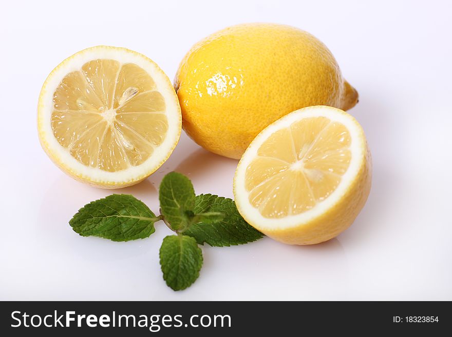 Two lemon with fresh green mint isolated. Two lemon with fresh green mint isolated