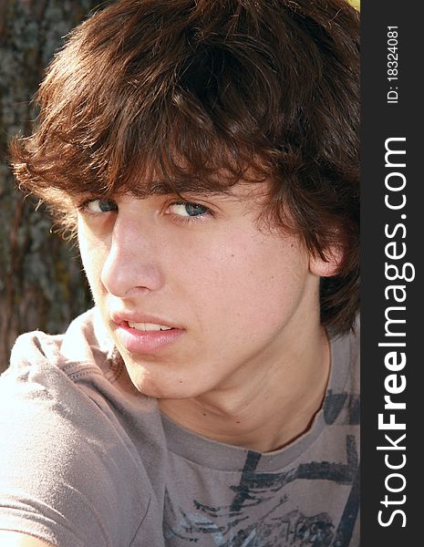 Teenage blue-eyed boy outdoor portrait. Teenage blue-eyed boy outdoor portrait