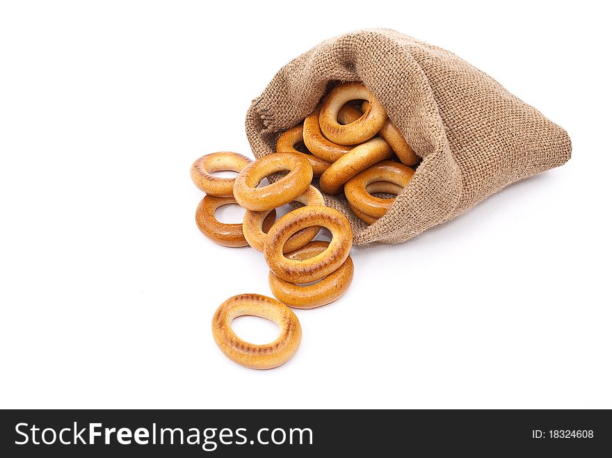 Burlap sack with bagels on white