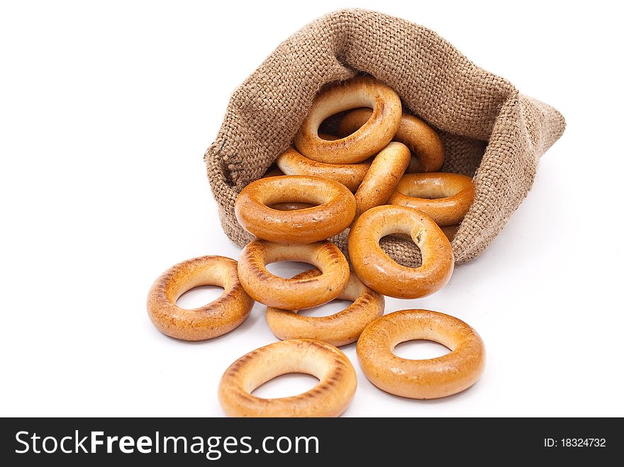 Burlap sack with bagels on white