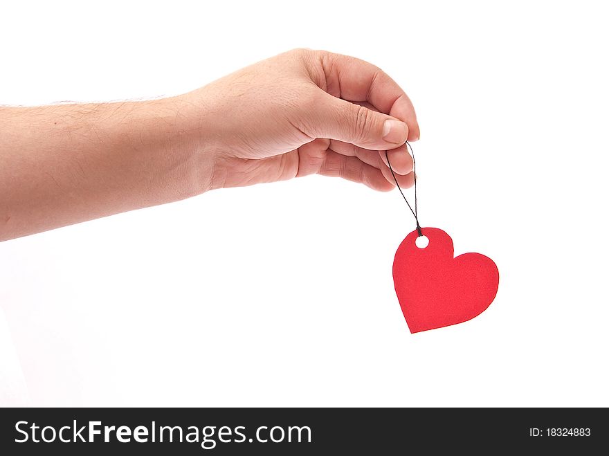 Hand with red heart tag on white