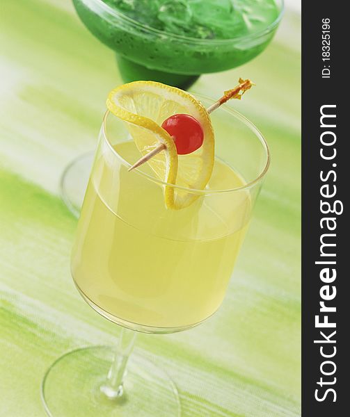 Rum punch, drink glass isolated on green background. Rum punch, drink glass isolated on green background