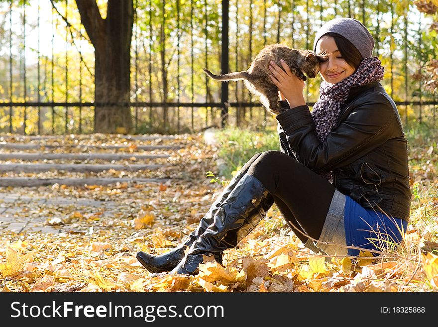 Young Girl With A Kitten Outdoors