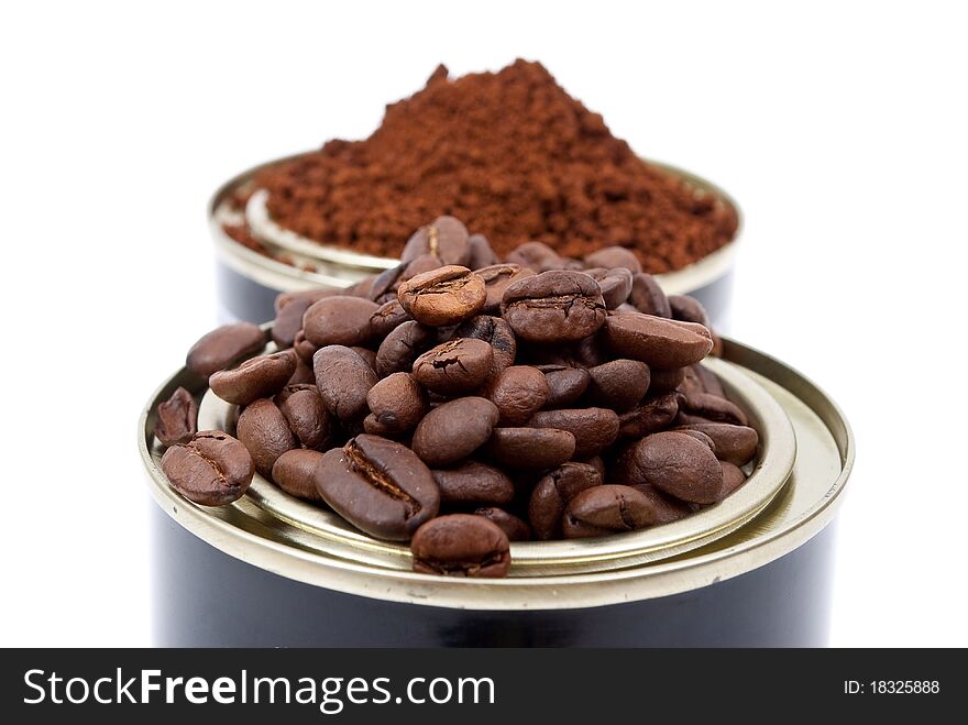 Coffee beans in tin cans on white