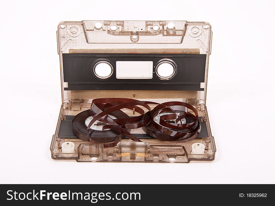 Broken audio cassette on white