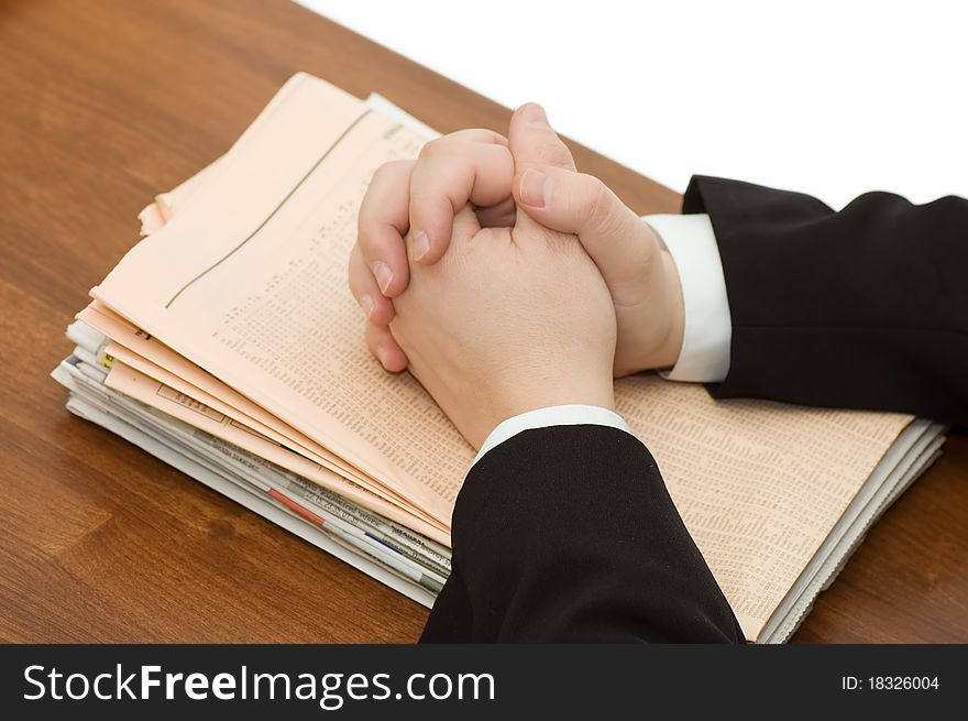 Hands Of The Businessman On A Pile Of Newspapers