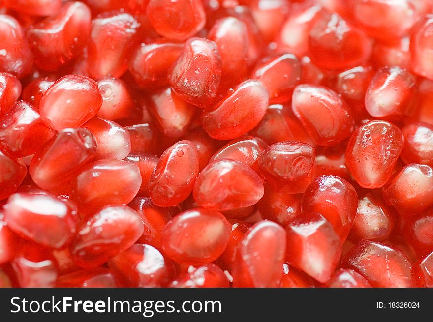 Macro of peeled ripe seeds pomegranate background