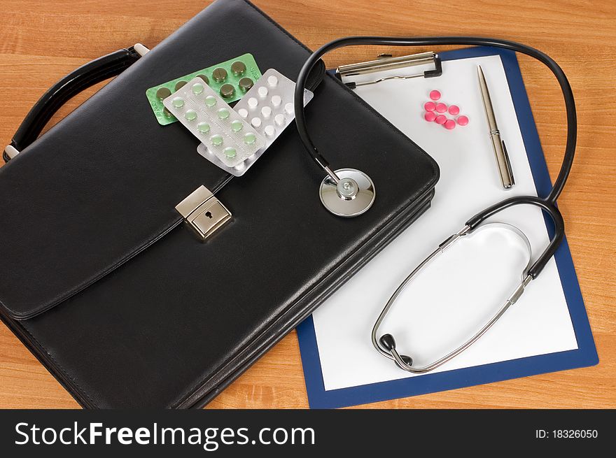 Black Portfolio And Phonendoscope On A Table