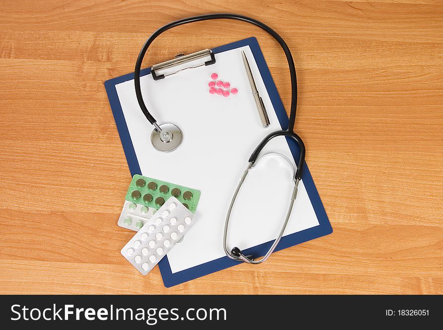 Blank clipboard with modern stethoscope still life