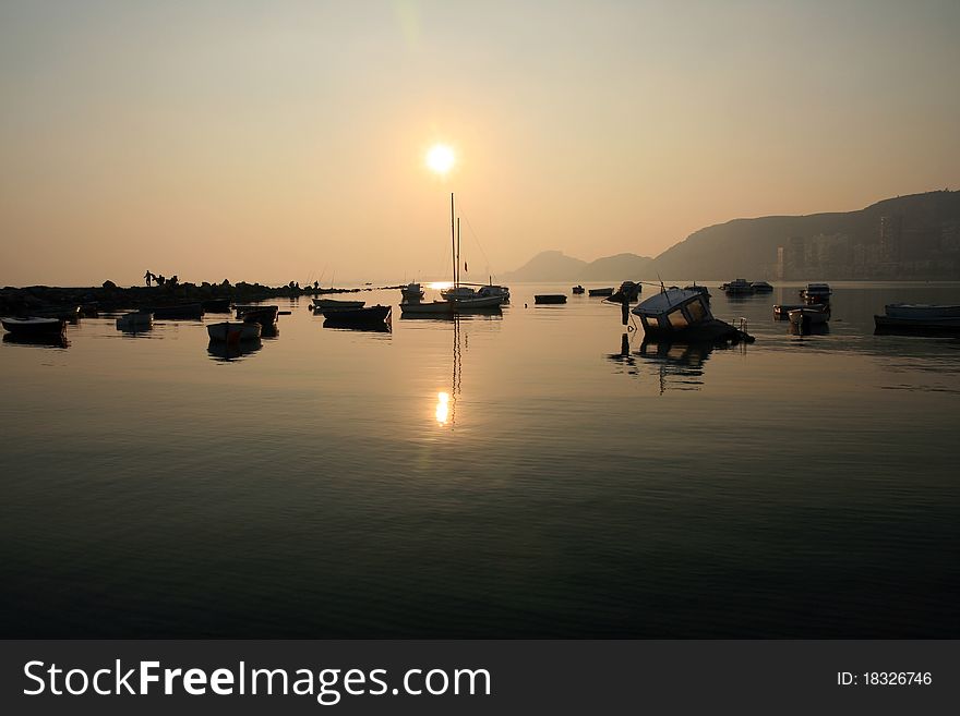 Sailing boats anchored with the sunset