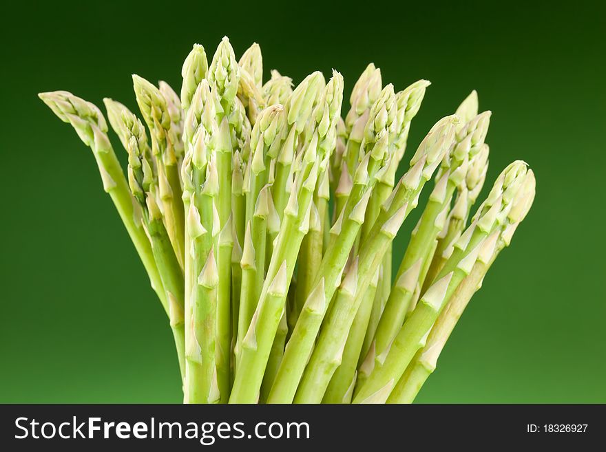 Sheaf of asparagus on a green background.
