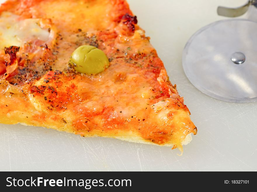 Slice of a delicious pizza with mozzarella cheese, tomatoes, basil, and olives. Slice of a delicious pizza with mozzarella cheese, tomatoes, basil, and olives.