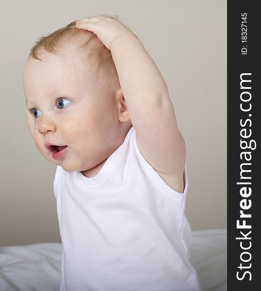 Cute baby boy with hands on head