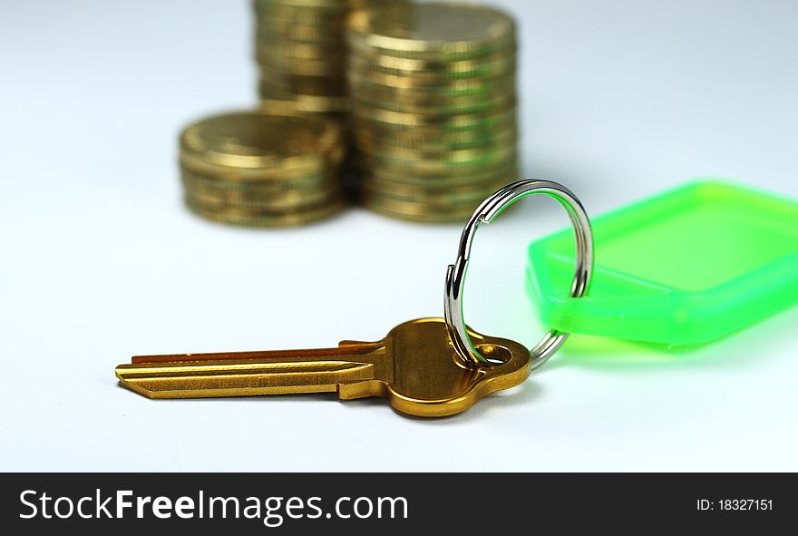 A Golden key placed in front of three piles of gold coins asking the question how good are your financial foundations. A Golden key placed in front of three piles of gold coins asking the question how good are your financial foundations.