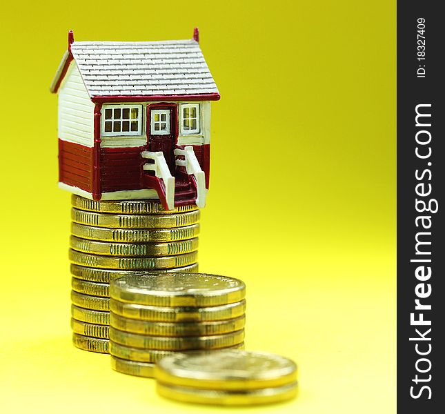 A house placed on a pile of gold coins, asking the question how good are your financial foundations. A house placed on a pile of gold coins, asking the question how good are your financial foundations.