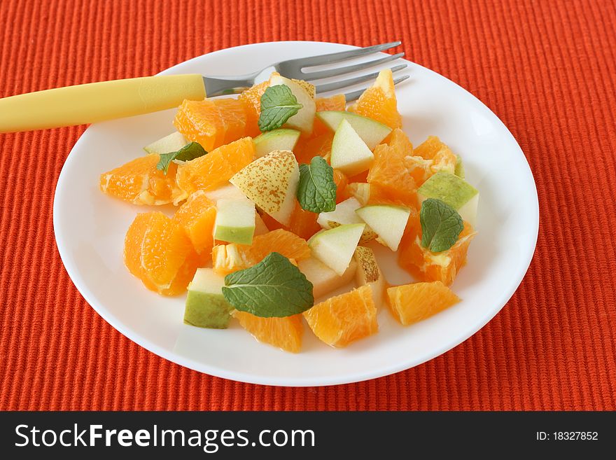 Fruit salad with mint on a plate