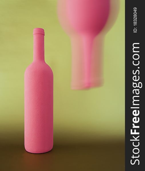 Two inverted red-pink bottle on golden background. Two inverted red-pink bottle on golden background