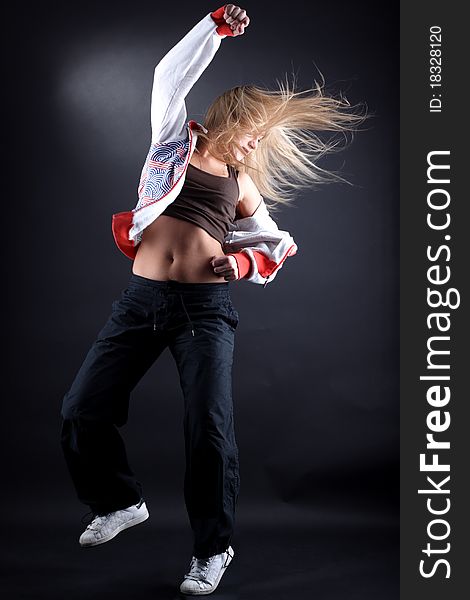 Woman modern dancer against black background