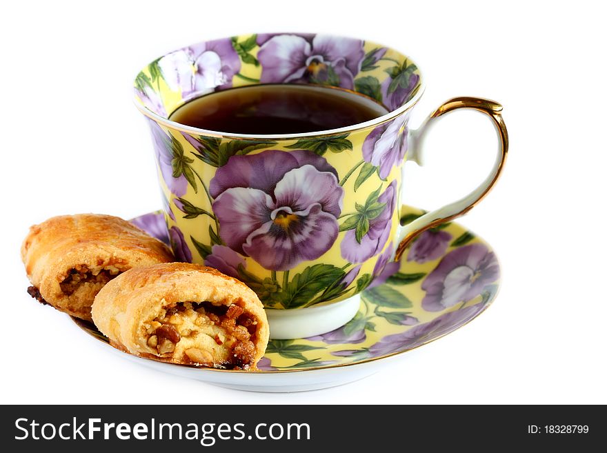 Isolated cup of tea with cookie on saucer