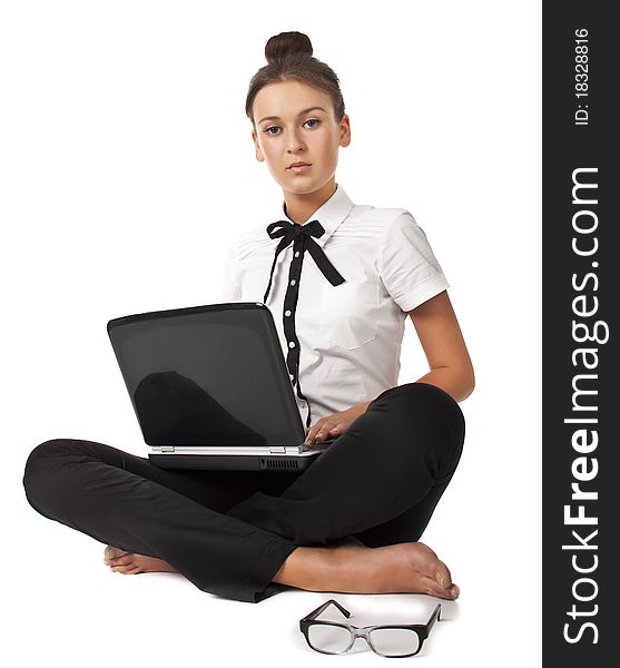 Beautiful girl sitting on the floor and works on a laptop keep the glasses in her hand isolated on white background Student Series