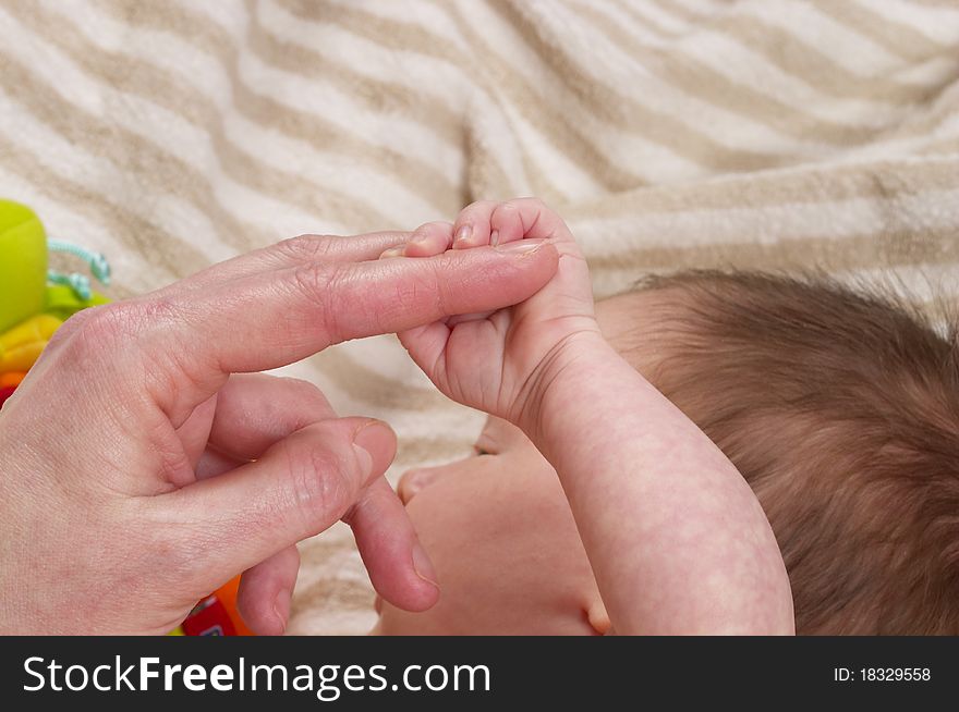 Little baby holding her mother's finger macro shot. Little baby holding her mother's finger macro shot