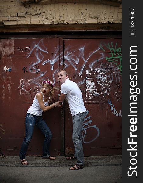 The guy and the girl breaking the lock on collars. The guy and the girl breaking the lock on collars