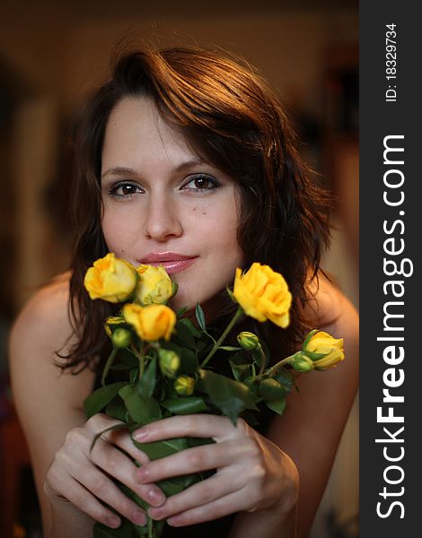 Portrait of the beautiful girl with a bouquet of yellow roses. Portrait of the beautiful girl with a bouquet of yellow roses