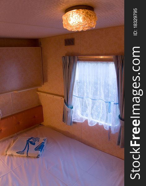 Overhead view of a comfortable, romantic mobilehouse or trailer bedroom. Overhead view of a comfortable, romantic mobilehouse or trailer bedroom.