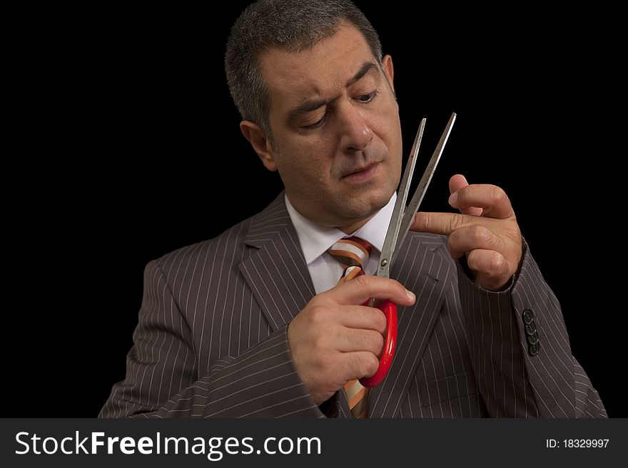 Businessman wearing suit, cutting nails with huge scisors - Humour - Bodycare. Businessman wearing suit, cutting nails with huge scisors - Humour - Bodycare