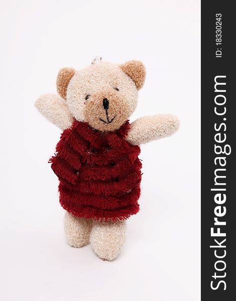 Teddy bear with red dress over white background