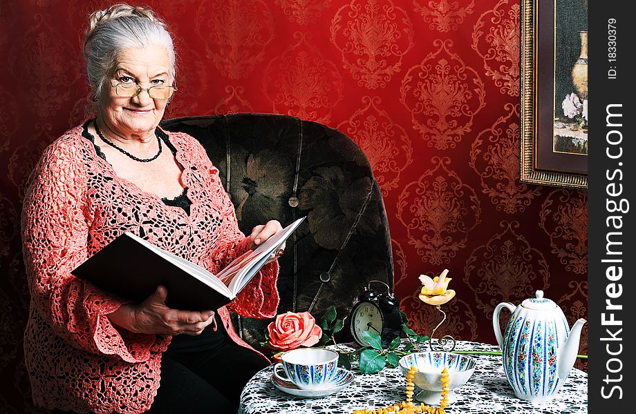 Portrait of a smiling senior woman having a rest at home. Portrait of a smiling senior woman having a rest at home.