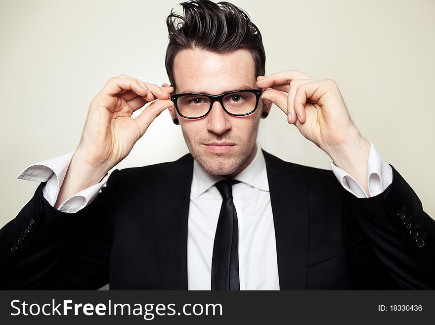 Young Businessman Holding Black Glasses